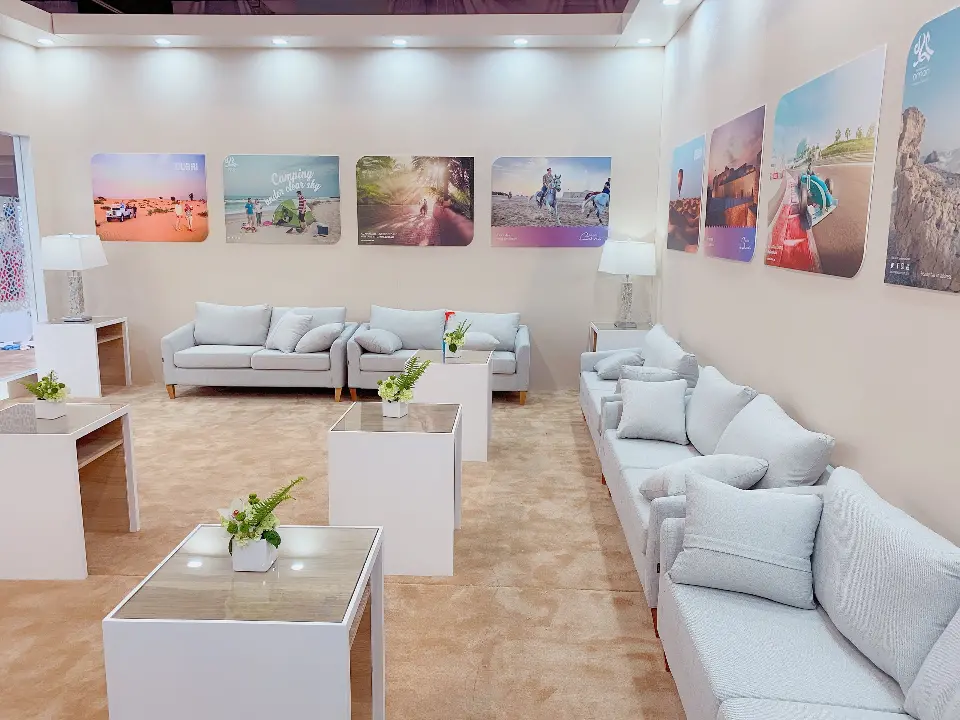 Sofa lounge with framed coastal photos on the white walls
