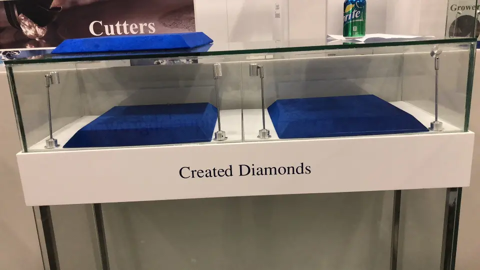 Two glass showcases with blue trays in front of the Cutters graphic panel