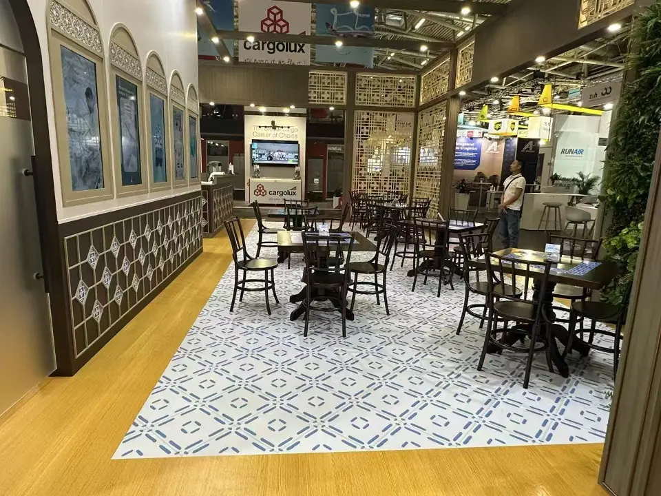 Cafe-style seating with bistro tables on a patterned tile floor inside the stand