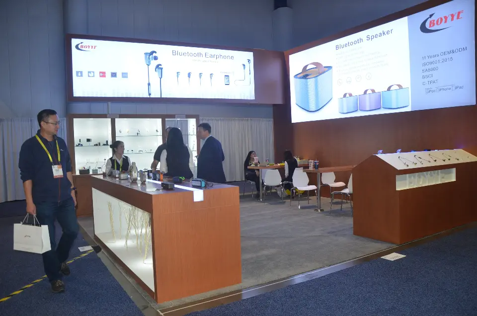 Visitors at the counter with lightboxes and house-shaped stand behind