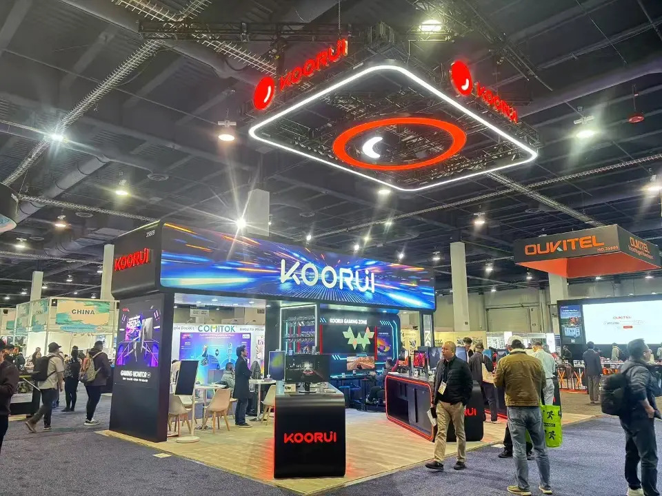 Front view of the Koorui stand at CES 2025 with a black logo plinth and busy aisle