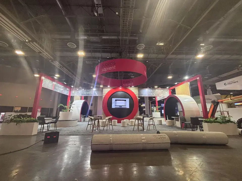 Front view of red pods, center screen and white lounge benches under the header