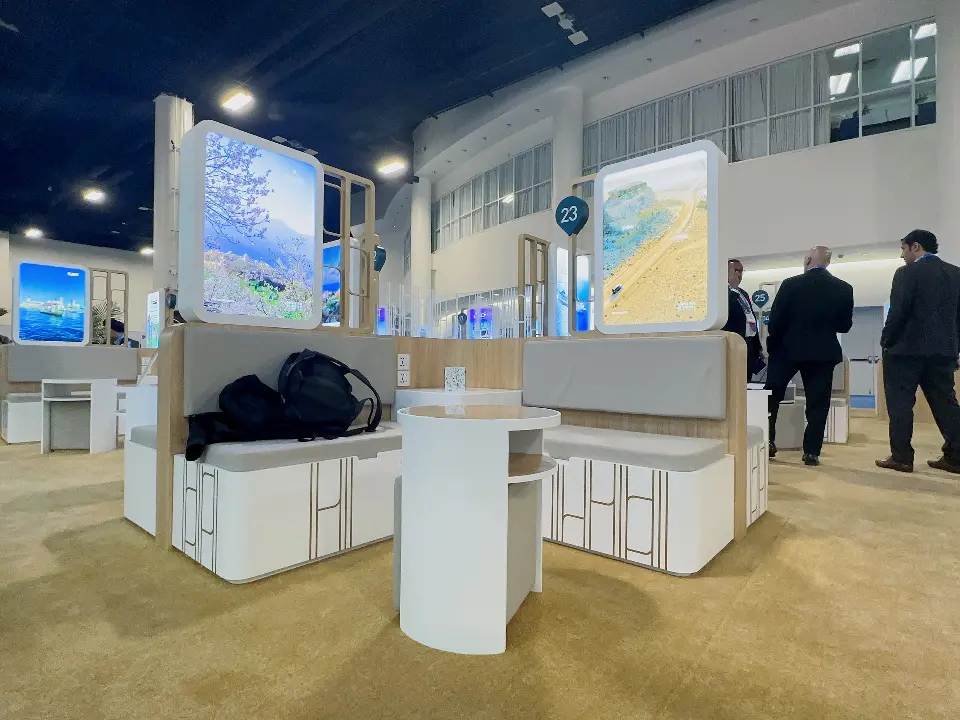 Curved white counters and backlit columns in the open meeting area