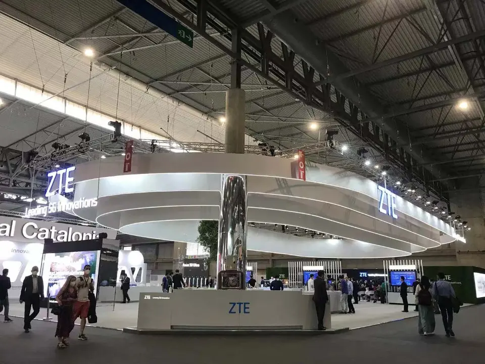 Layered canopy rings over the booth edge with a screen on the far left