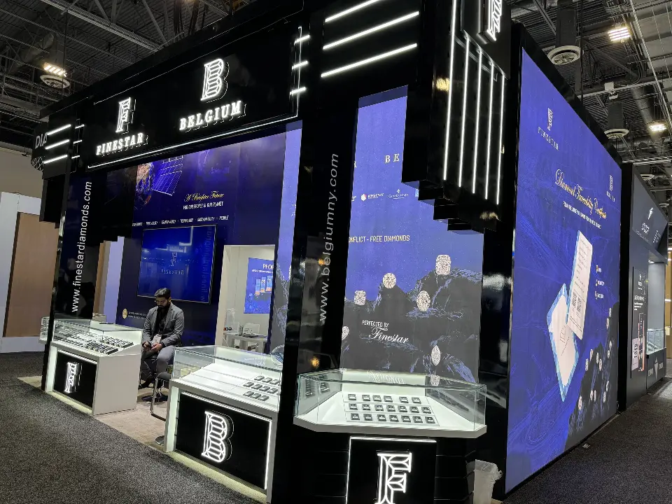 Finished Finestar Belgium booth with glass showcases, navy graphics and black light-bar columns