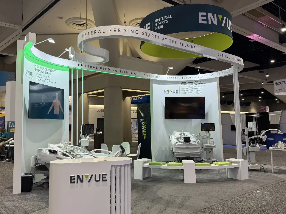 ENVUE logo counter in front of the green-lit band and white vertical slats