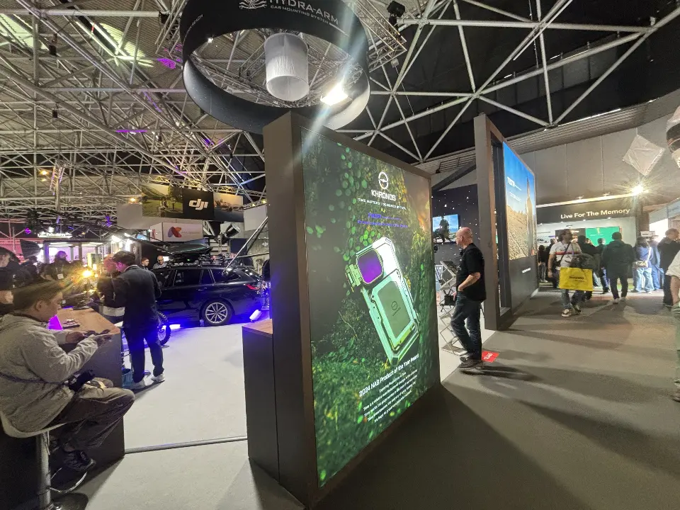 Lit Hydra Arm PRO tower beside the crowded booth floor