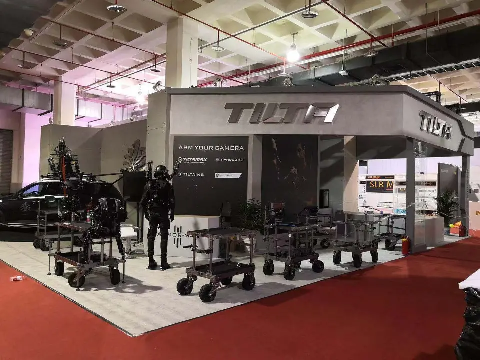 Full view of the booth with TILTA fascia, car display and rig carts