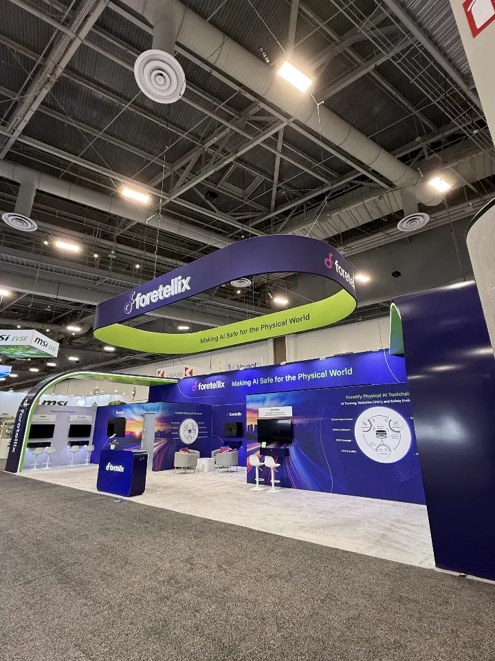 Wider aisle shot showing the full length of the navy and lime-green booth