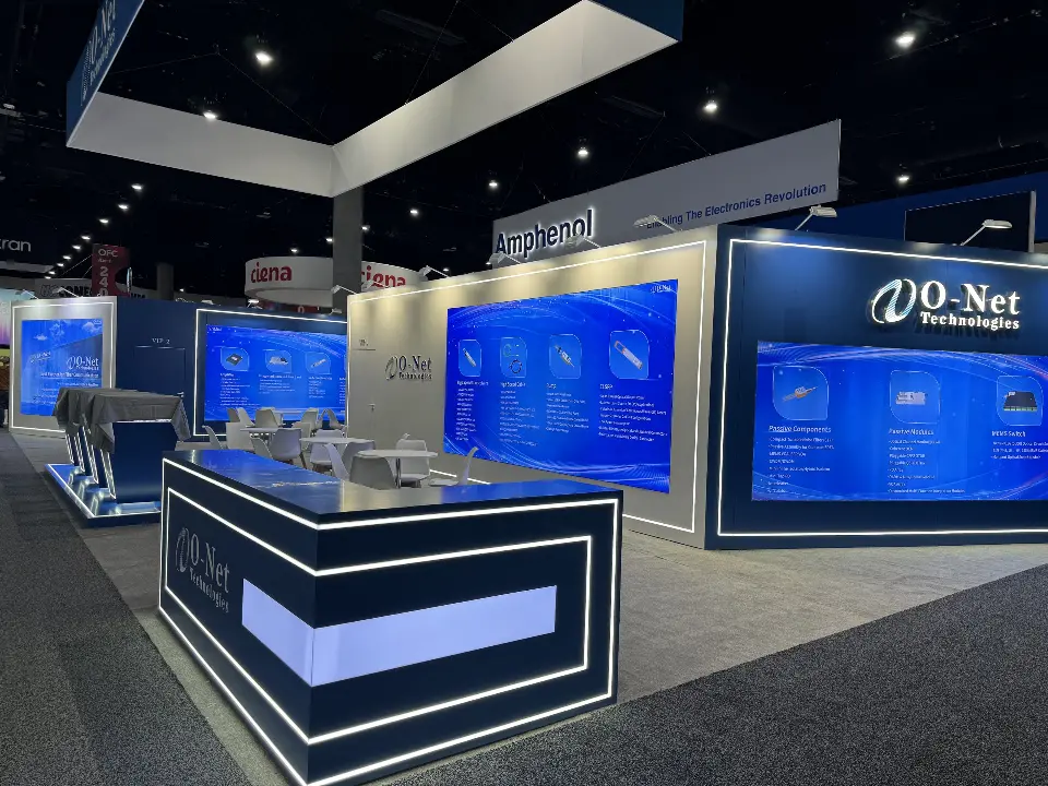 Lit O-Net counter in front of product walls, white caf&eacute; tables and VIP room doors