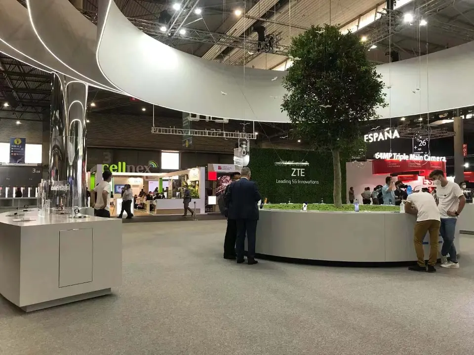 Tree and white counters under the canopy seen from a side aisle