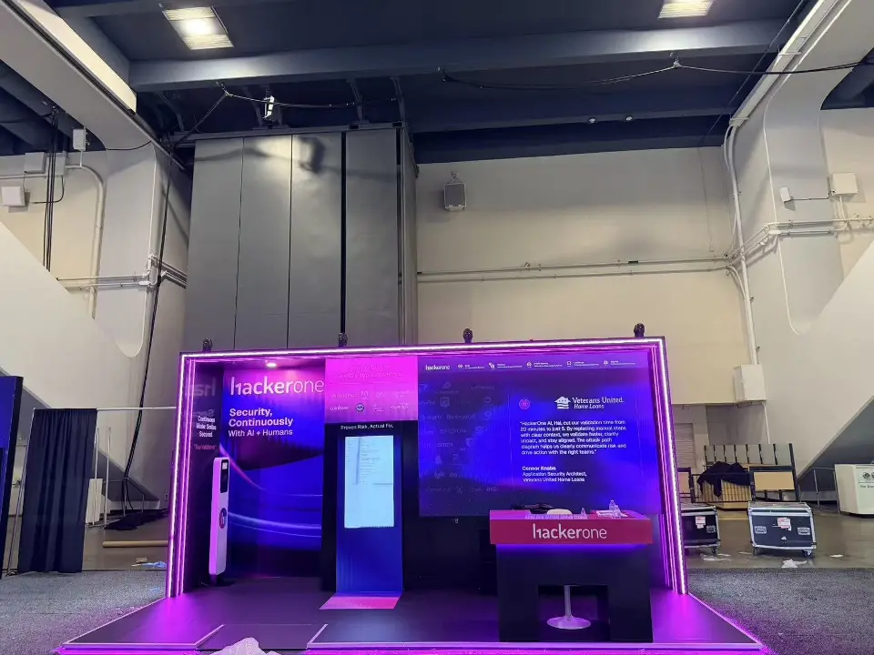 Front view from further back showing kiosk, counter and purple lit base