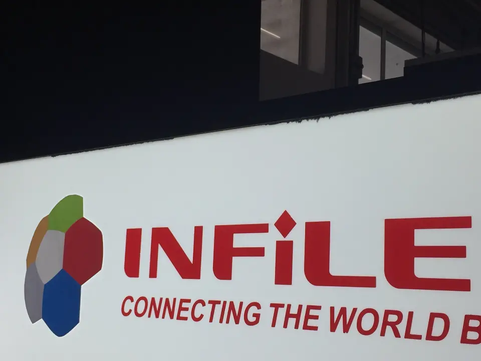 Close-up of the red and blue INFiLED logo on a white panel