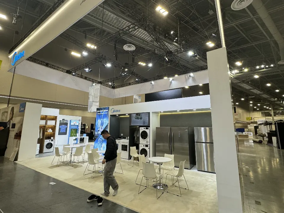 Open lounge with caf&eacute; tables and refrigerators lined along the wall