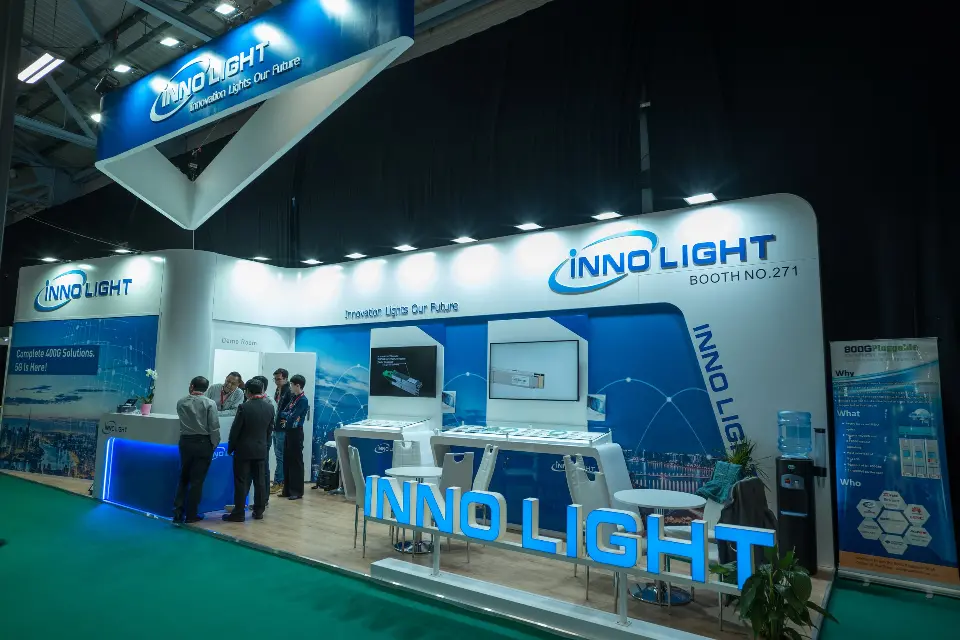 Visitors at the counter with blue base glow beneath the hanging canopy