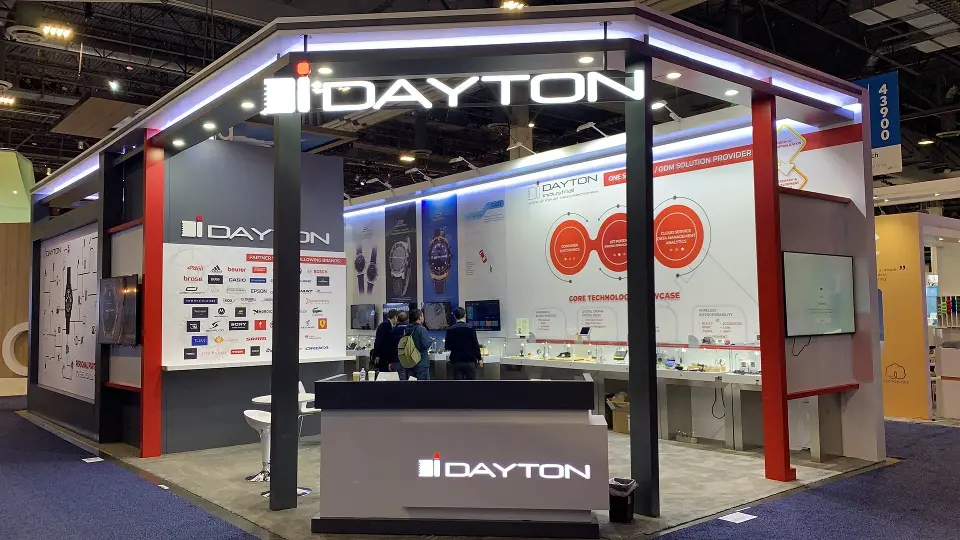 Straight-on view of the open booth with the DAYTON header, counter and visitors