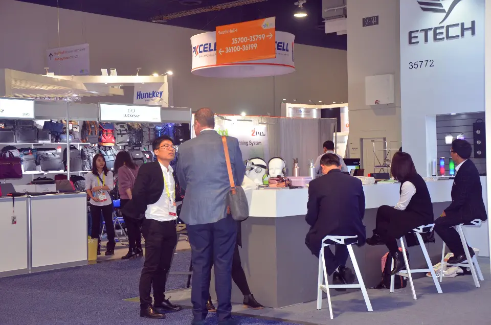 Guests seated on white stools at the counter under the ETECH tower logo