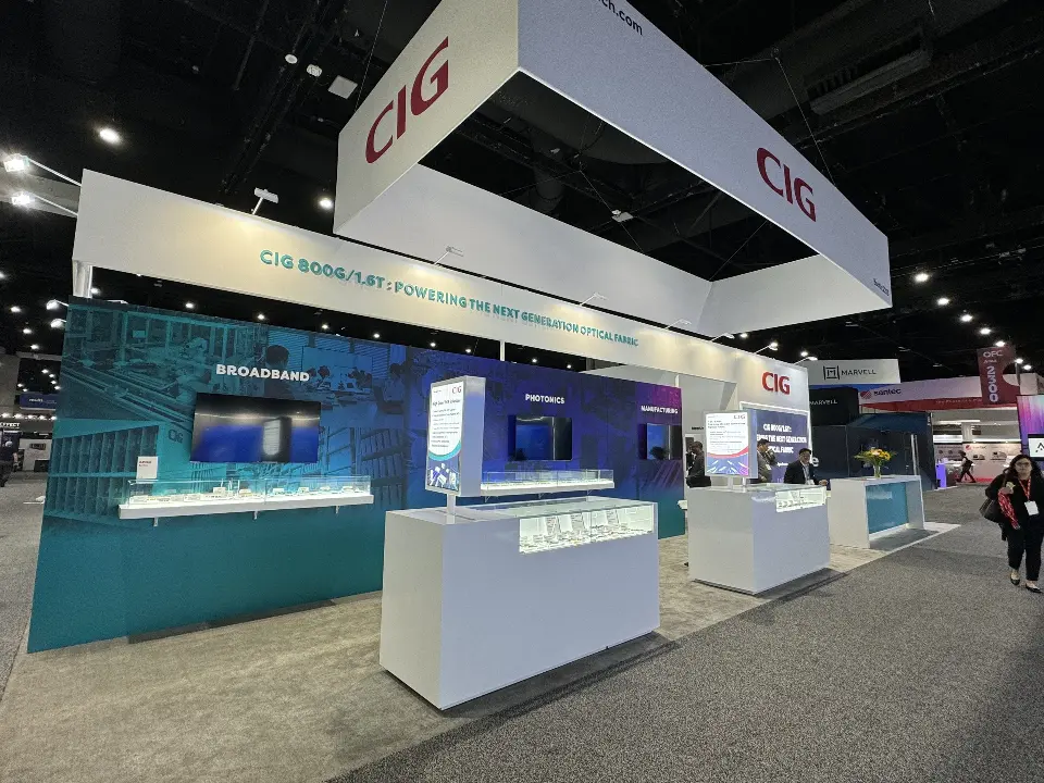 Teal wall with screens and lit display counters beneath the white CIG header