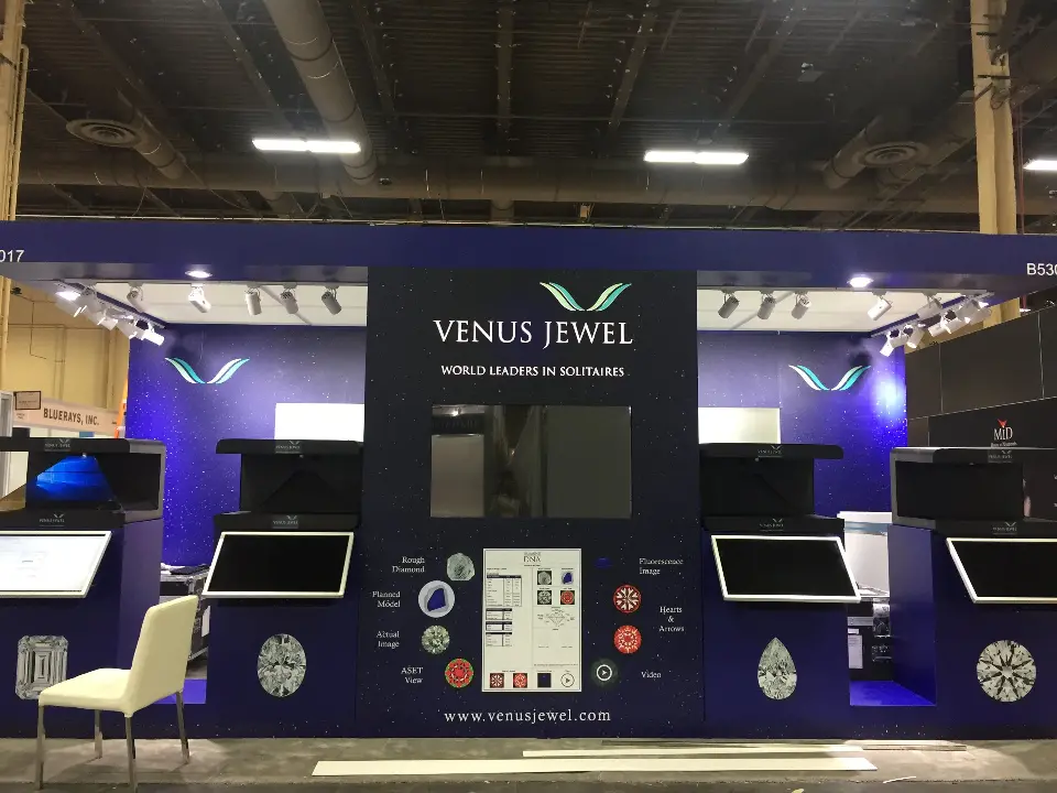Straight-on view of the Venus Jewel kiosk wall with a diamond DNA graphic