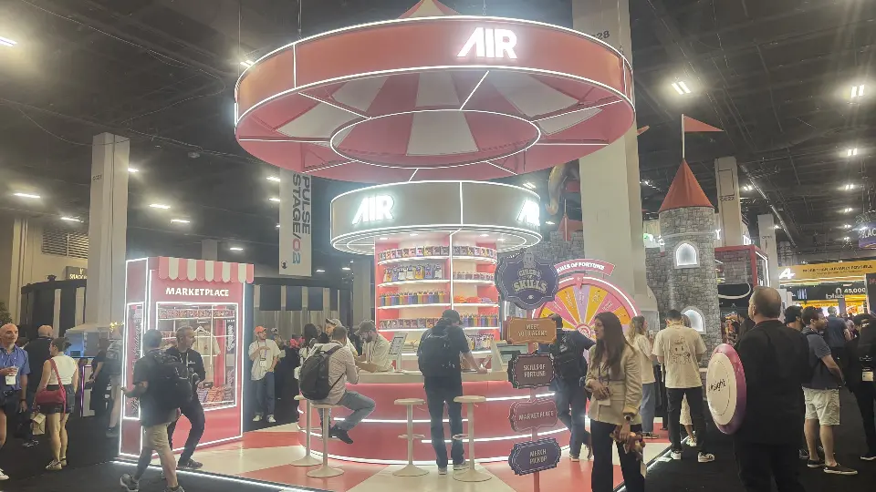 Front view of the AIR booth with lit counter and Marketplace kiosk