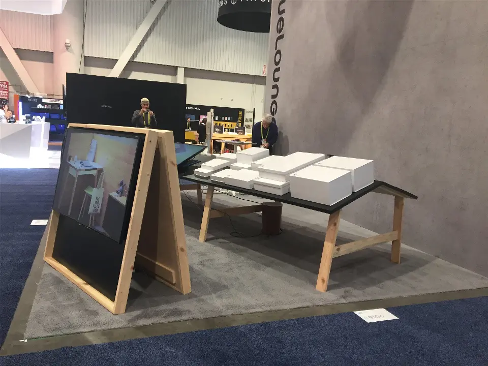 Close angle of the Bluelounge easel display and table along the grey textured wall