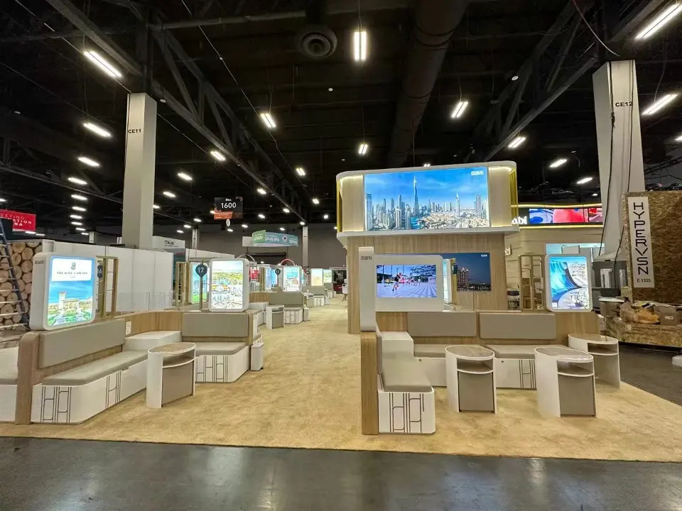 Pavilion seating booths with grey upholstery beneath the Dubai header