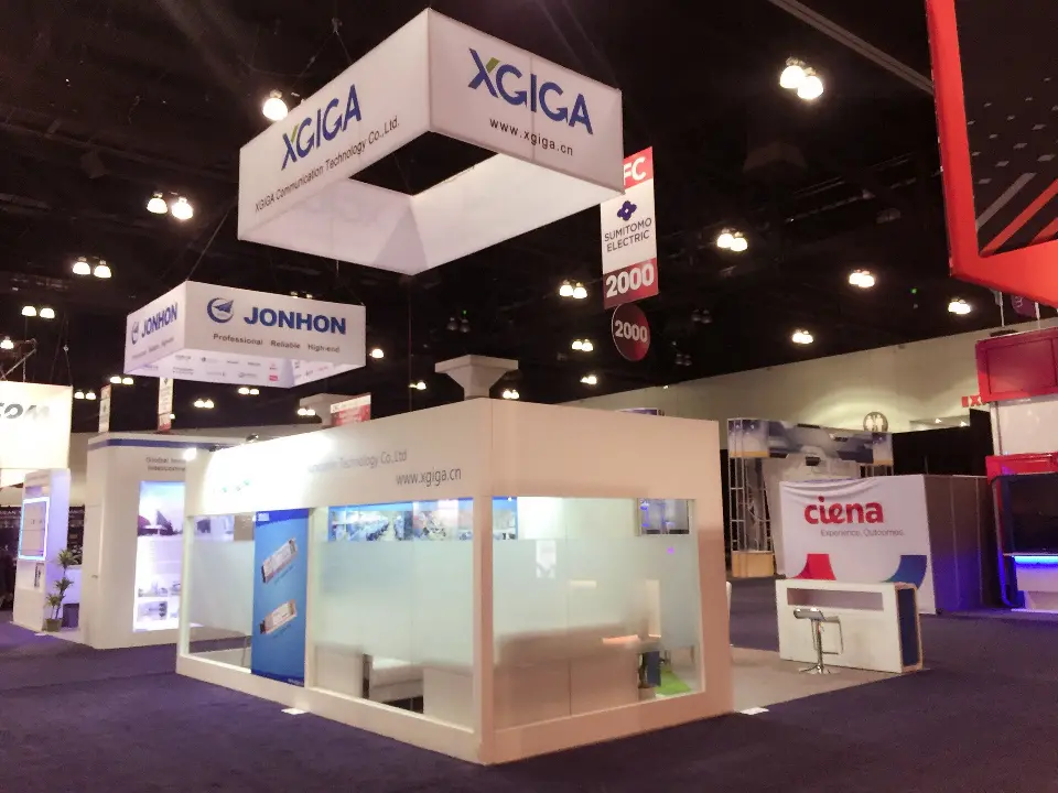 Corner view of frosted glass meeting room under the square XGIGA hanging sign