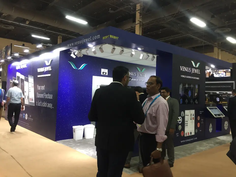 Guests talking in front of the starry navy walls and V logo