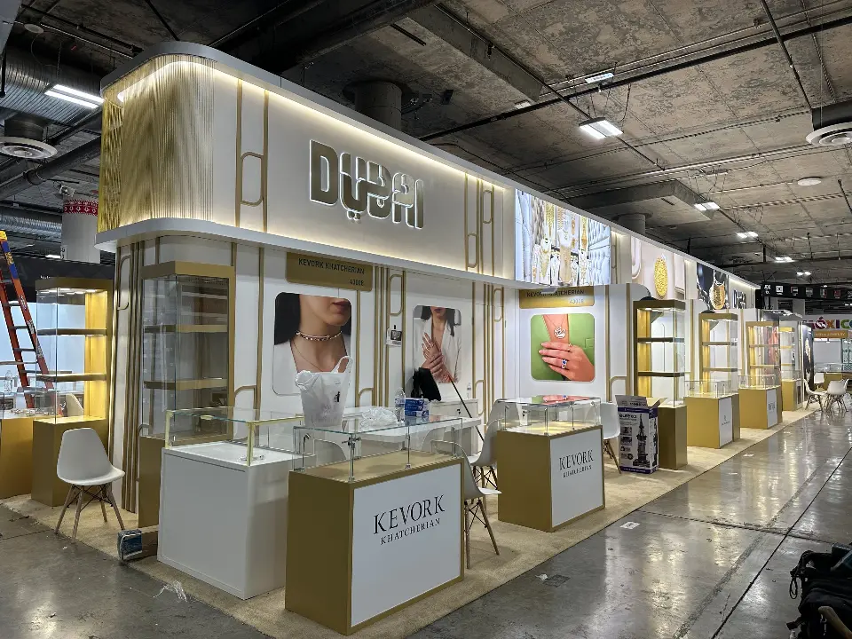 Finished pavilion corner with lit gold showcases and a Kevork logo counter