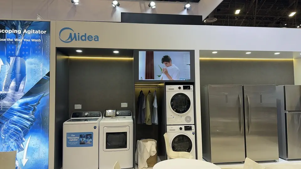 Laundry display with a stacked washer and dryer beside a blue backlit graphic