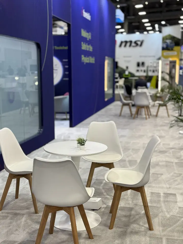 Cafe table area with white chairs near the frosted room