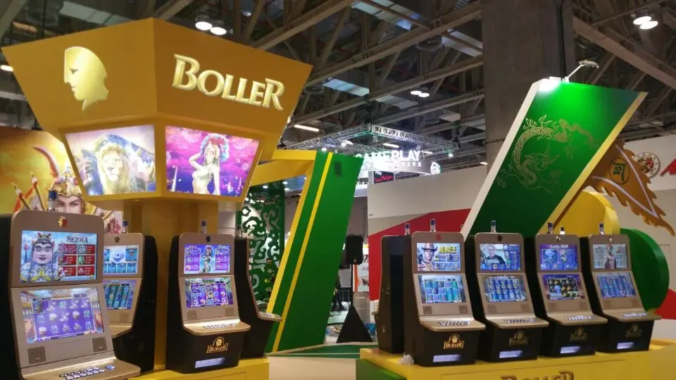 Close view of the lit BOLLER fascia over game artwork and machine screens