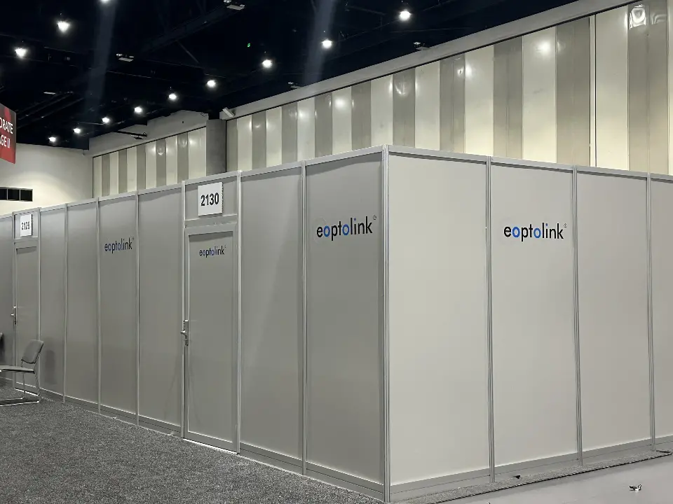 Row of white enclosed meeting rooms with small eoptolink signs