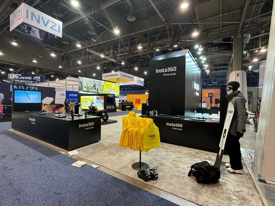 Side of the booth with a black counter and a figure display