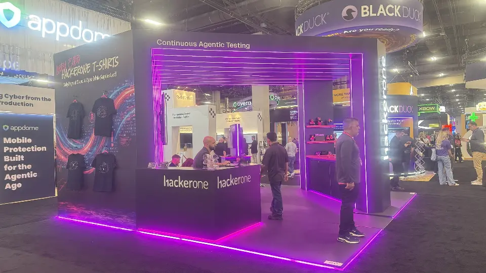 Angled view of the T-shirt wall and black counter with magenta floor edge lighting