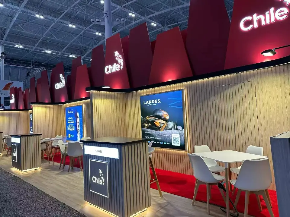 Chile pavilion counters with backlit logos, seafood graphic and white meeting tables