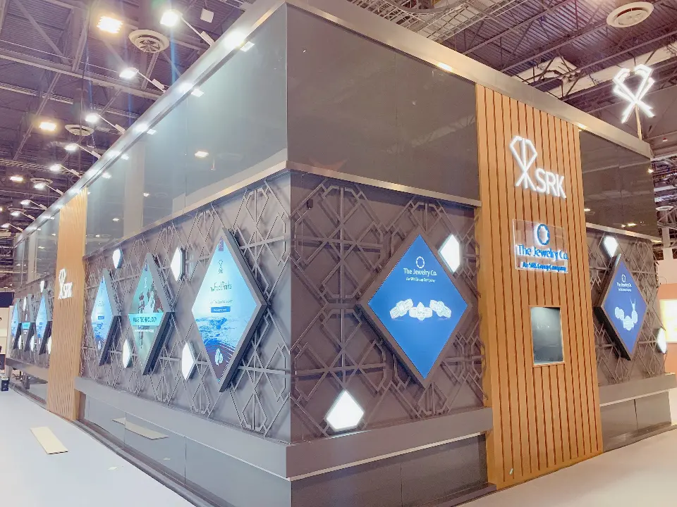 Corner angle with diamond light boxes, lattice wall and SRK logo on a pillar