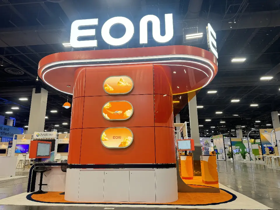 Back of the tower with three lit oval windows under the EON sign