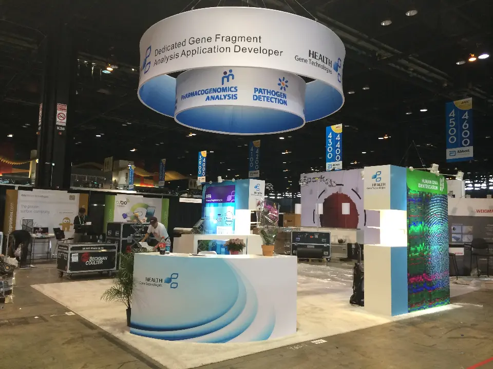 Health Gene Technologies stand at AACC 2014 with two-tier hanging ring and curved blue wave counter