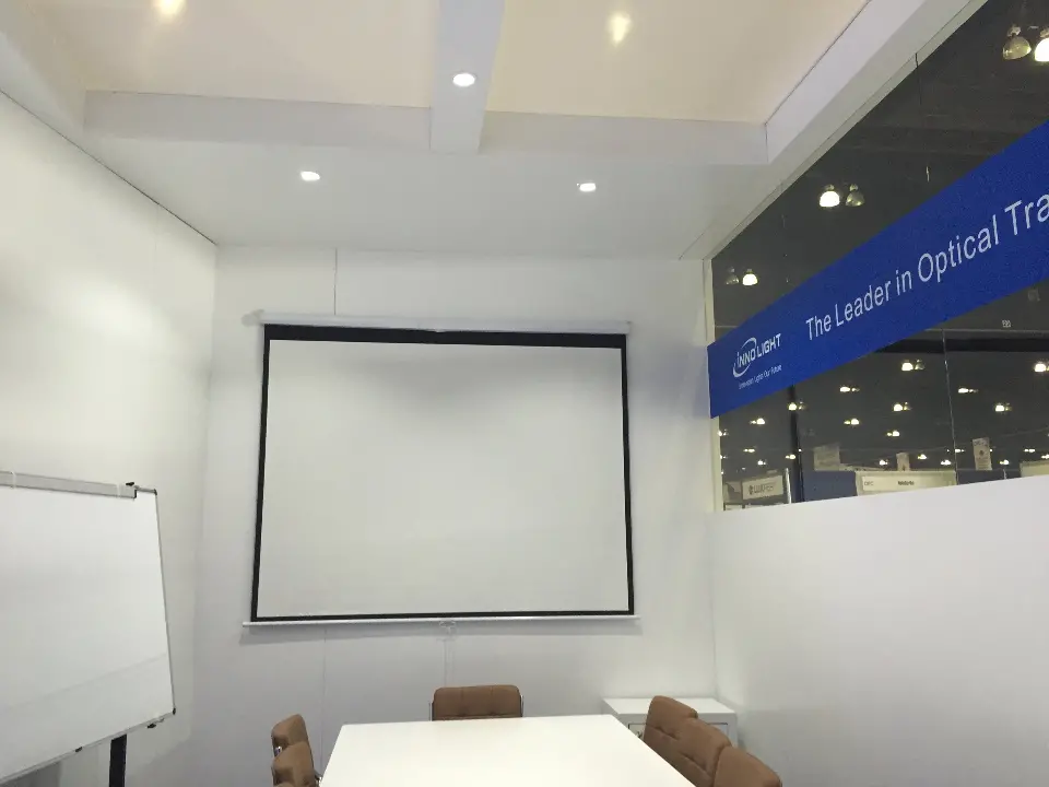 Projection screen and whiteboard on the white meeting room wall