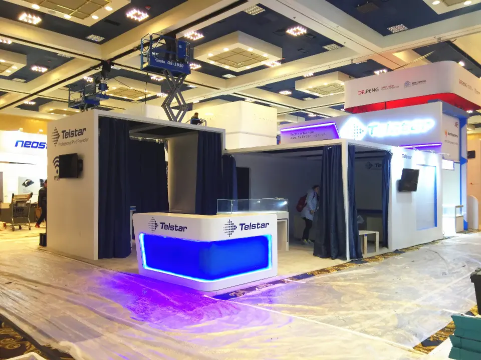 Wider front view of the blue-lit counter under a hanging sign