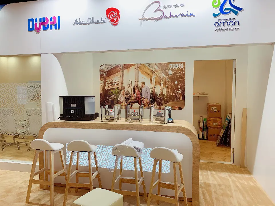 Coffee bar with wood-look stools in front of a wall mural