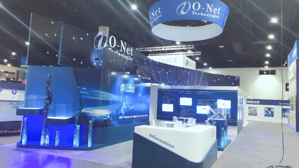 Blue-lit O-Net booth with round hanging sign, curved white counter and display cases
