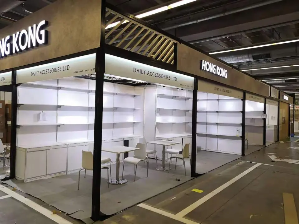 Row of shelving booths with a table and chairs and lit edges along the fascia
