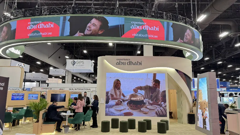 Experience Abu Dhabi pavilion with suspended ring screen above a lounge and large screen