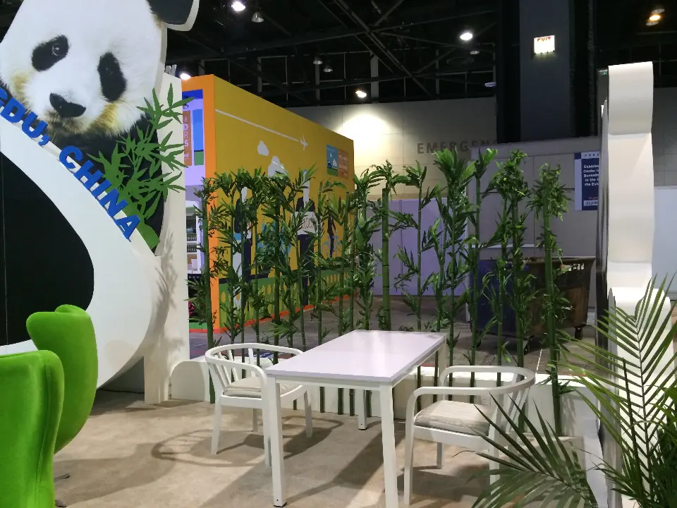 Lounge corner of the Chengdu Airport stand with green egg chairs, white table and bamboo screen