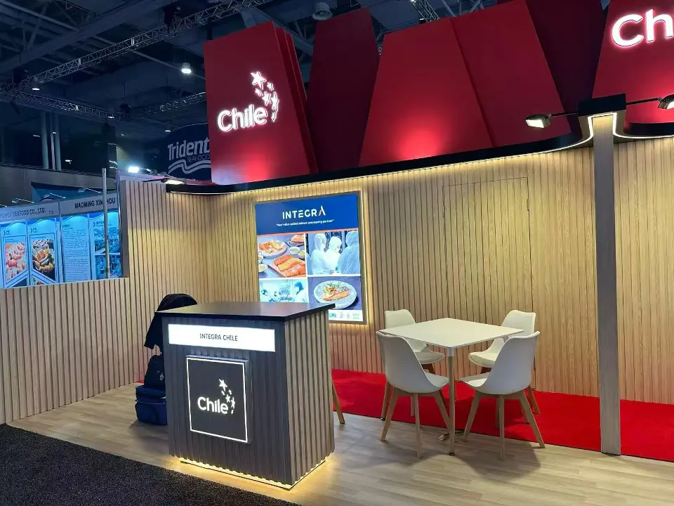 Backlit Chile counter, wood-slat wall and seafood graphics under the red header panels