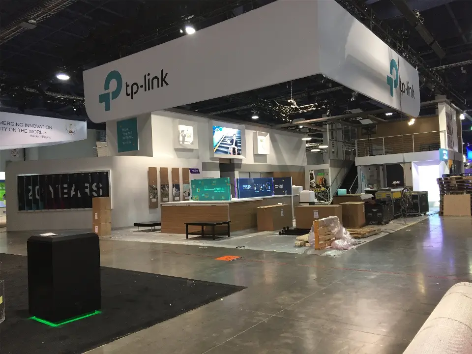 During build-up: wide view of the tp-link island with crates, pallets and 20 Years wall