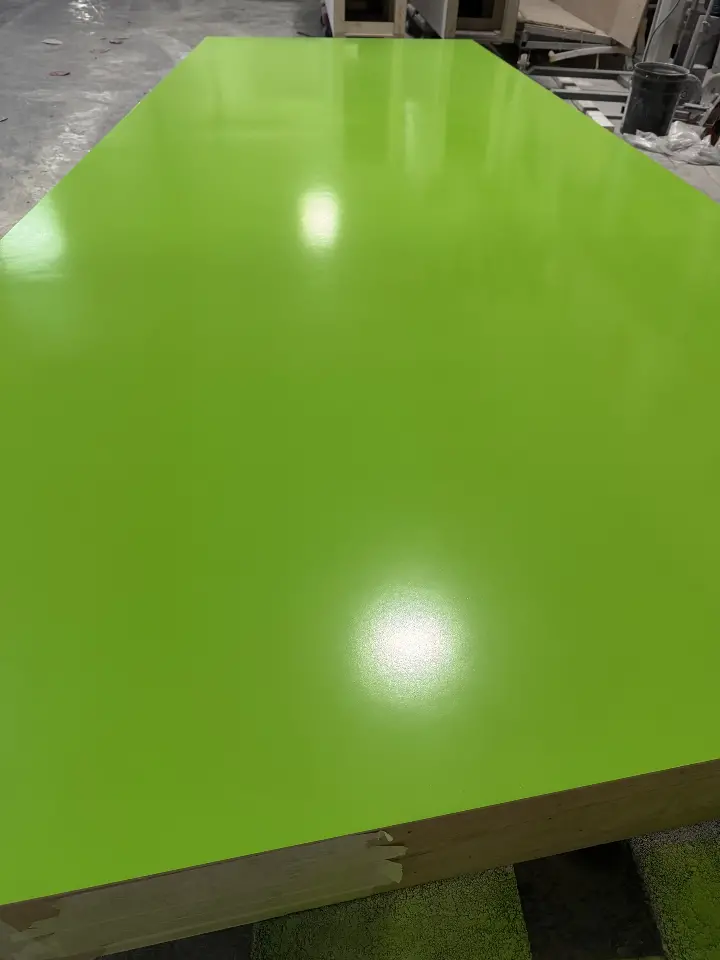 During build-up: glossy lime-green panel surface before shipping