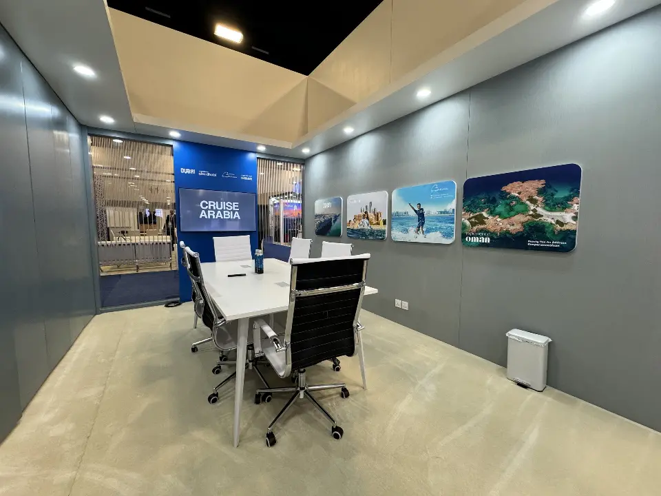 Meeting room with a white table, black office chairs and photo panels